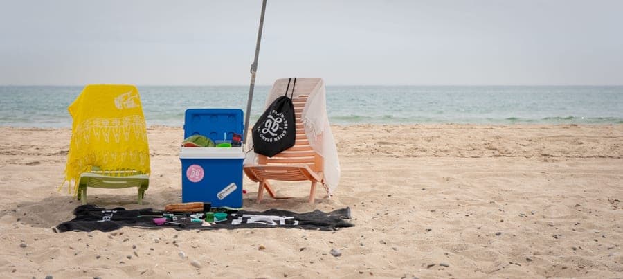 A sandy beach with a towel on a clear summer day