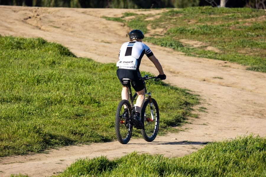 A cyclist riding along a sunny trail
