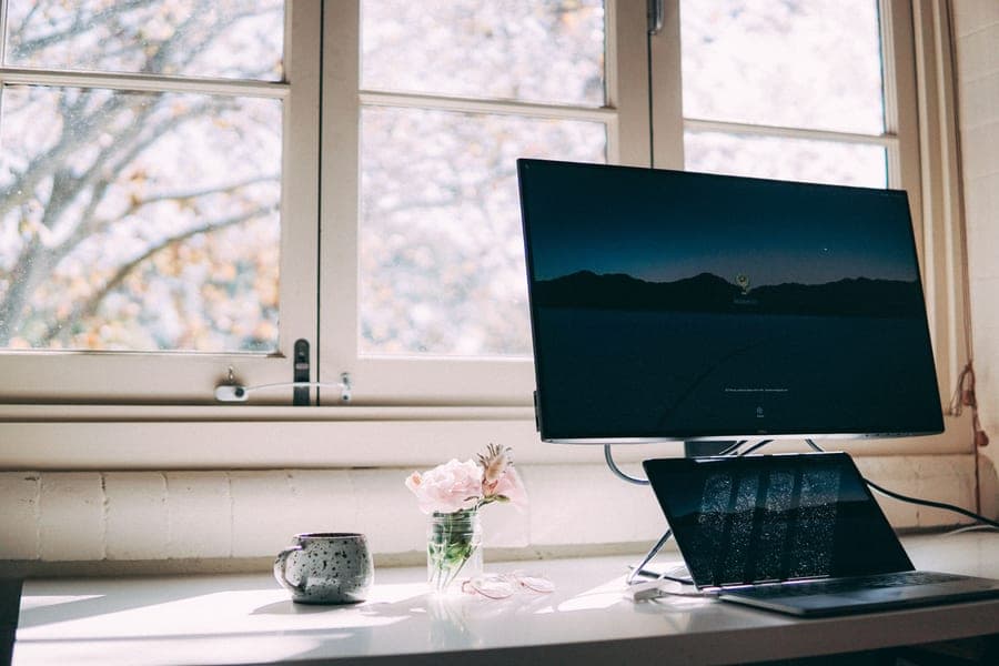 A home office desk workspace in morning light