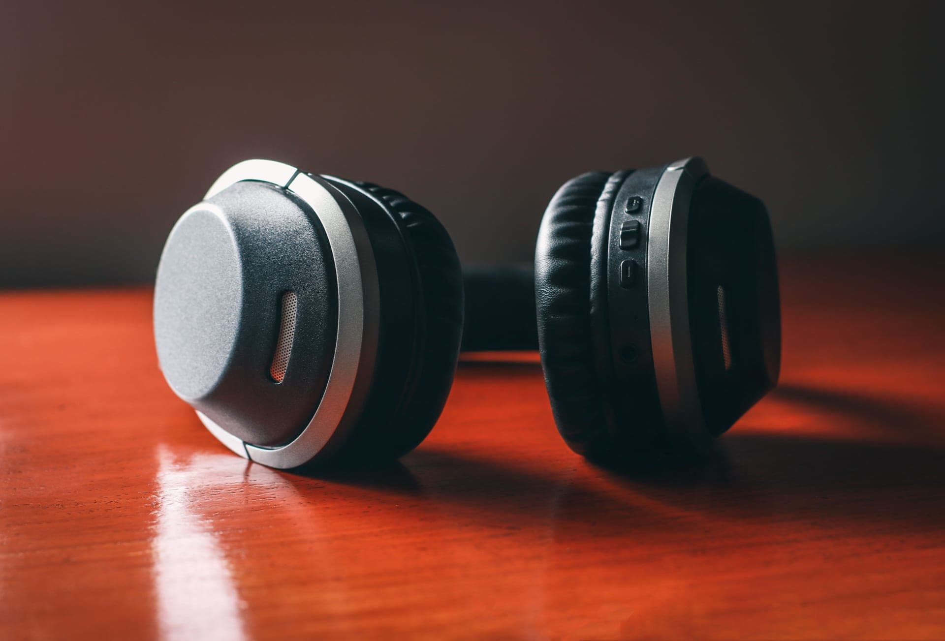 Wireless headphones resting on a wooden table