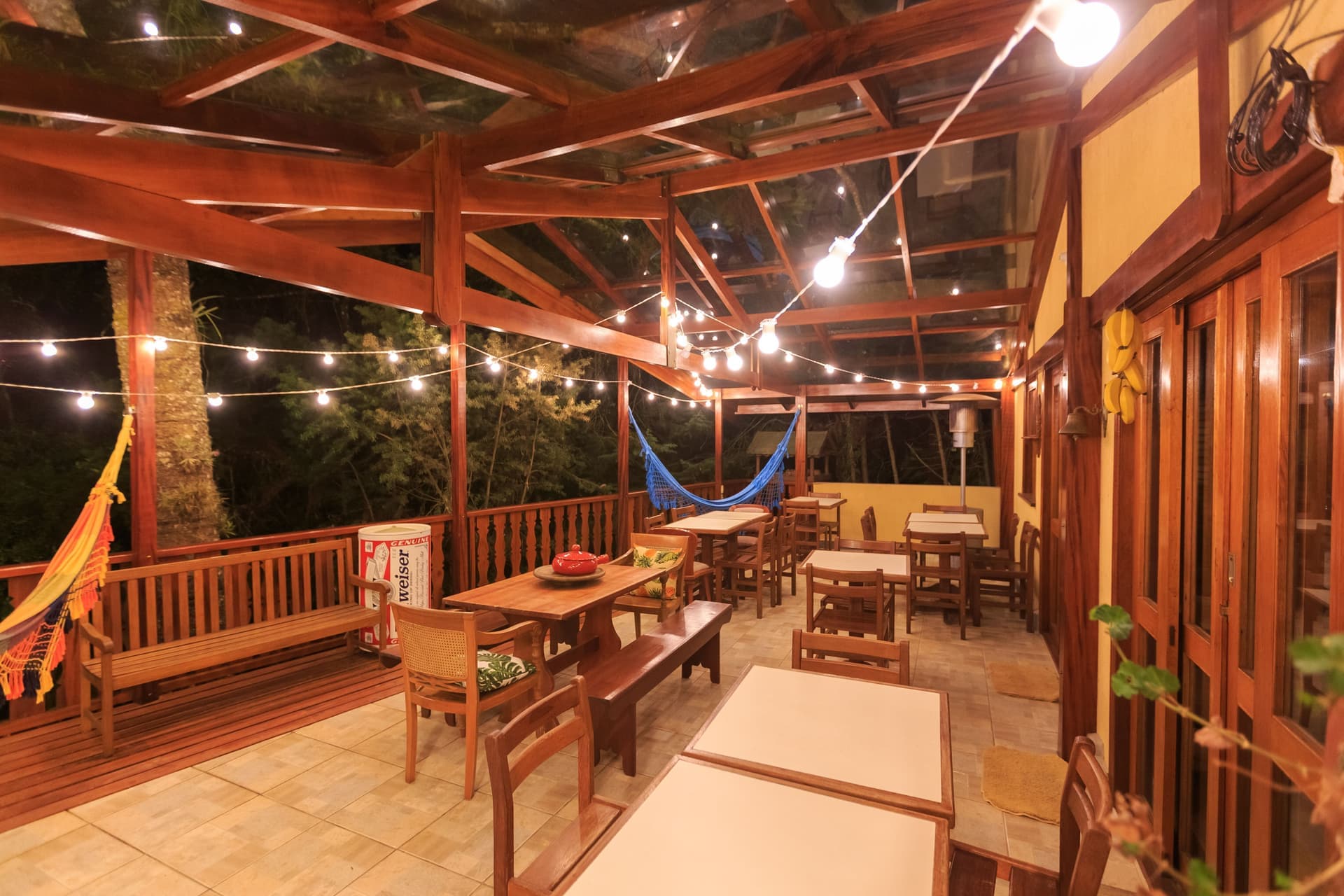 An outdoor patio at night lit with string lights and seating