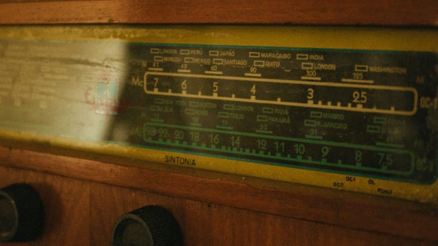 Close-up of a vintage radio tuner showing its frequency dial