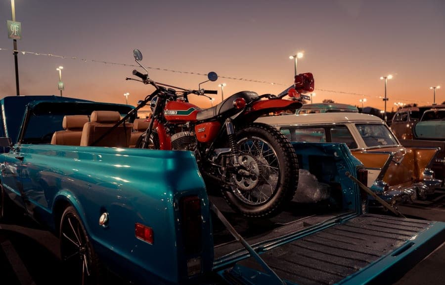 A tailgate gathering beside a truck in a parking lot