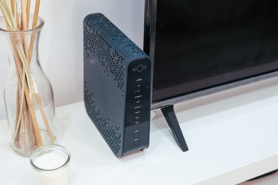 A home technology setup with a wireless router beside a television