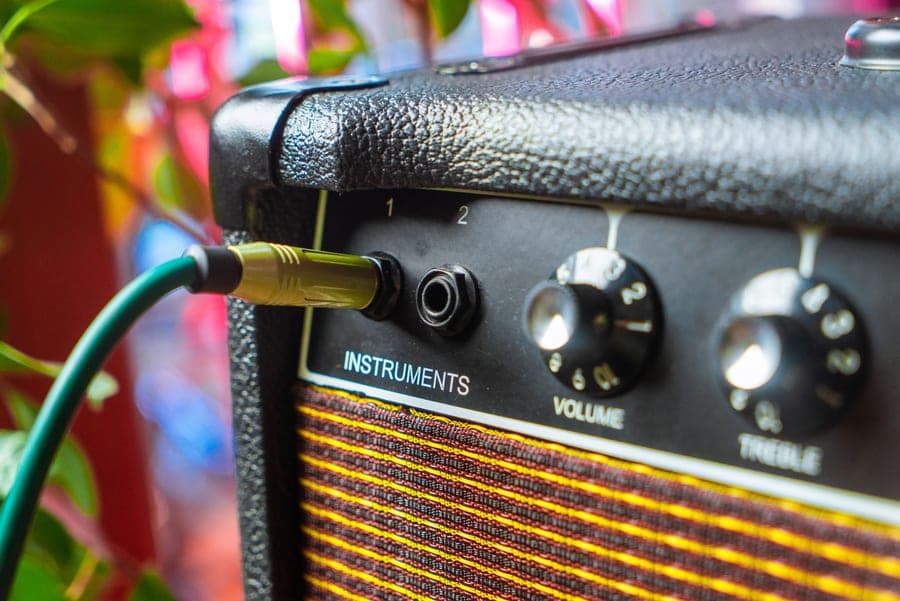 Close-up of an amplifier with an instrument cable plugged into its input